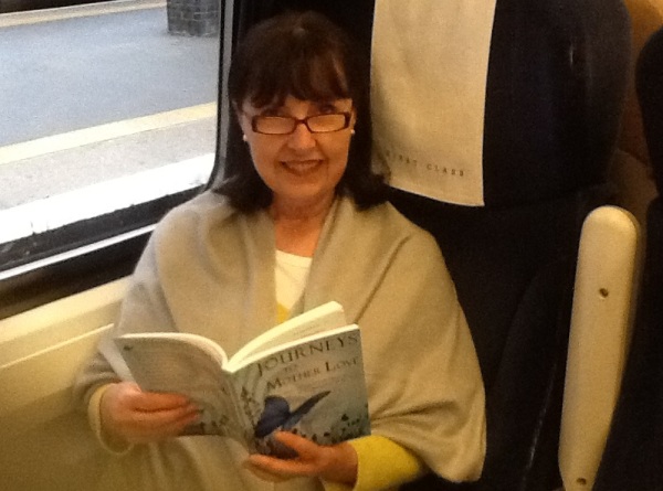 A friend reading "Journeys to Mother Love" while traveling in England, October 2012.